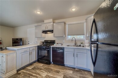 Kitchen featuring a peninsula, under cabinet range