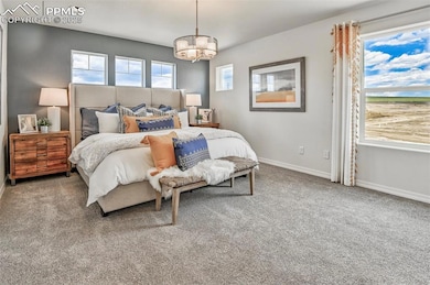 Bedroom featuring carpet floors and baseboards