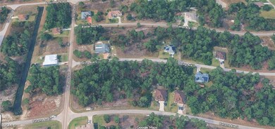 View of property location with a tree filled landscape