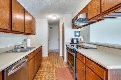 Kitchen featuring appliances with stainless steel finishes, sink, a textured ceiling, and light tile patterned floors