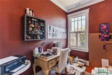 This front room is currently used as an office or 