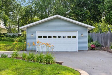 The large, oversized two-car garage boasts a high vaulted ceiling, providing ample space for vehicles, storage, and workshop needs.  (26' x 24' with a 8' x 16' door)
