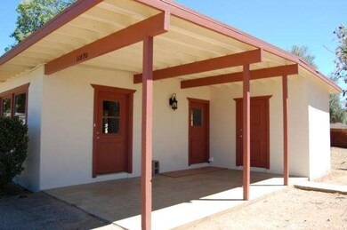 Covered carport/front porch gives access to the li
