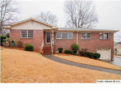 Front view of home. Lots of green grass in summer.