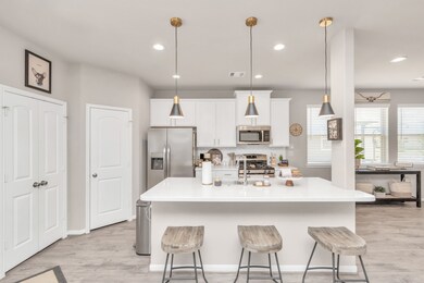 A stunning white kitchen, where a breakfast bar of