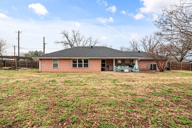 Rear view of house with a patio area and a lawn