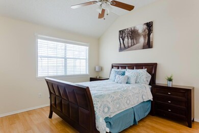 Bedroom featuring wood finished floors, lofted ce