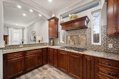 Kitchen featuring ornamental molding, stainless st