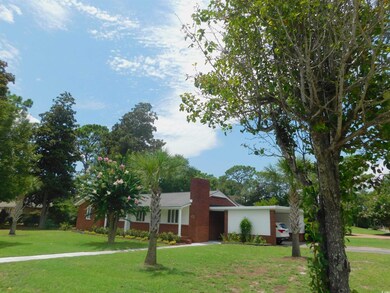 Single story home with a front lawn