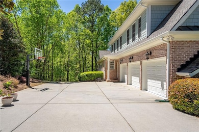 View of property exterior featuring a garage, bric