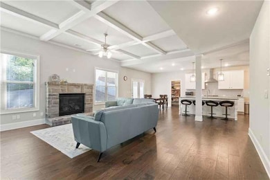 Living room with dark wood-style flooring, baseboa