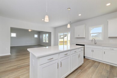 Kitchen featuring sink, white cabinets, a kitchen 