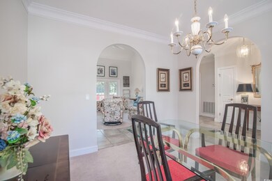 Dining area featuring crown molding and light tile patterned flooring