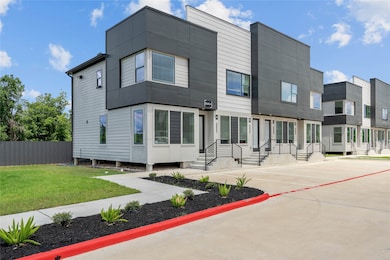 Side view of the 32 unit  complex with gated access and clean landscaping.