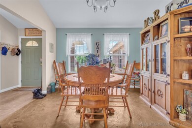 Dining space featuring a chandelier and baseboards