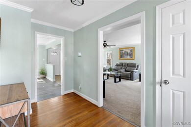 Hallway featuring crown molding and hardwood / woo