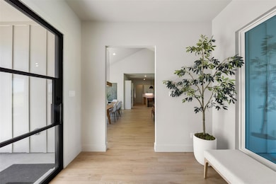 Foyer featuring light wood finished floors, baseb
