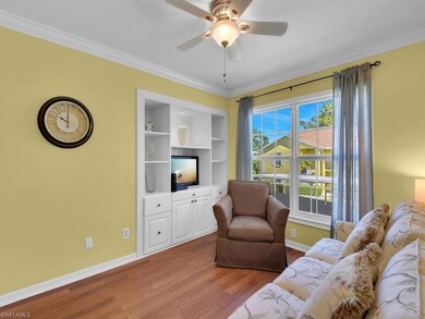 Living area featuring wood finished floors, crown 
