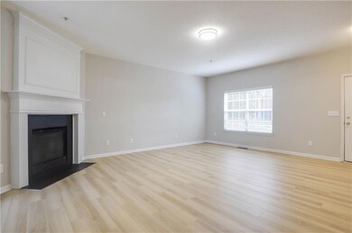 Unfurnished living room with light wood-type flooring and a large fireplace