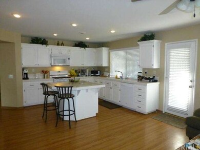 View of the kitchen and door leading to the rear p