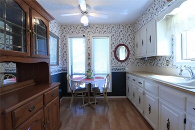 Kitchen offers low-maintenance floors, tons of natural light, eat-in kitchen & ample cabinet space.