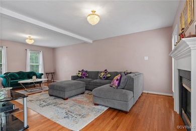 Living area featuring wood finished floors, a fire