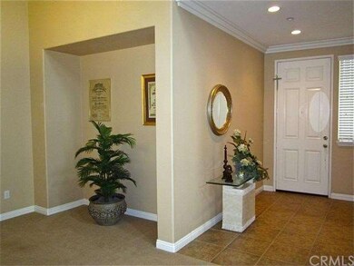 Formal entryway, recessed lighting, crown molding.