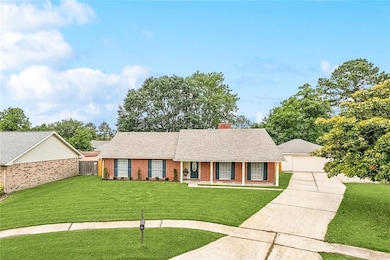 Extra long driveway with additional storage to the right of garage for boat or camper storage.