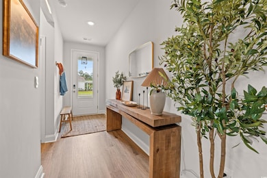 Entrance foyer with light wood-style floors, baseboards, and recessed lighting