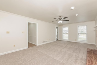 Carpeted spare room with crown molding and ceiling