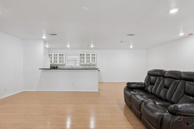 Living room with light wood finished floors and r