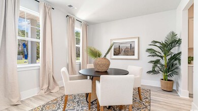 Dining area featuring light wood-style floors and baseboards