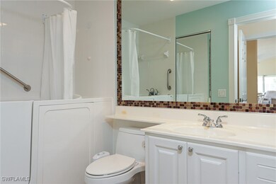 Bathroom featuring toilet, vanity, a shower with s
