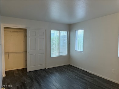 Unfurnished bedroom featuring dark wood-type floor