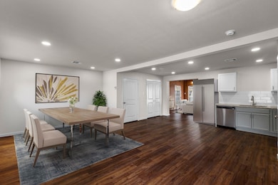 Dining room featuring sink and dark hardwood / woo