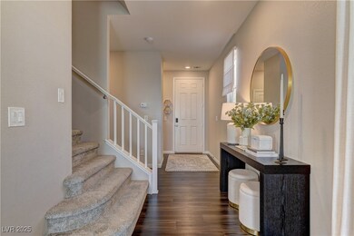 Foyer entrance featuring stairs and dark wood-styl