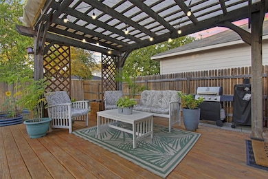Wooden terrace featuring a grill, a pergola, and 