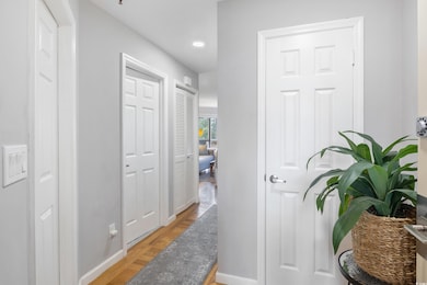 Hallway with baseboards and recessed lighting