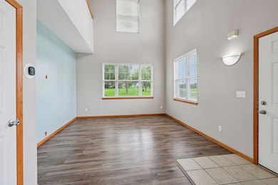 The bright living room has two-story ceilings.