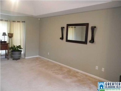 Living room is spacious and in neutral tones.