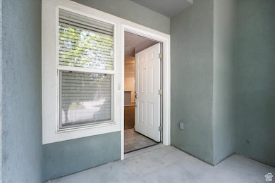 View of exterior entry featuring stucco siding