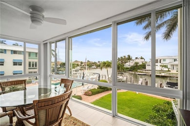 Sunroom featuring a water view