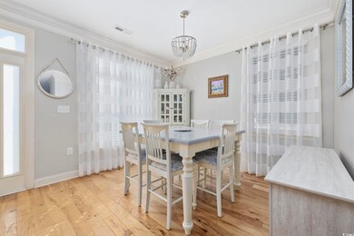 Dining space featuring crown molding, a healthy am