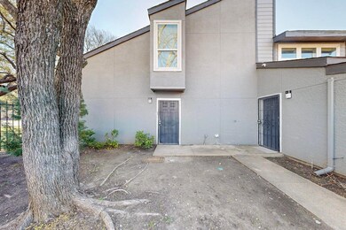 Back of property featuring stucco siding and a pat