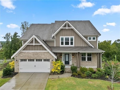 Craftsman-style house with board and batten siding, brick siding, and covered porch