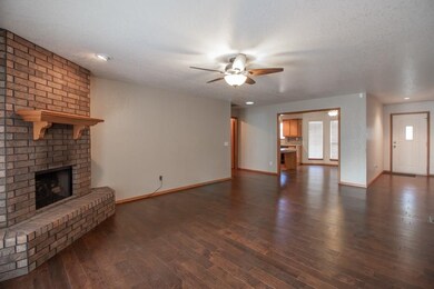 Living room flows to the dining and kitchen.