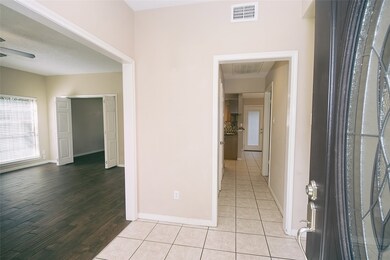 The foyer opens to the family area to the left with wonderful large tile flooring and neutral colors.