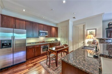 Spacious kitchen features granite counter tops, st