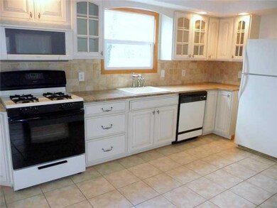 Kitchen Updated kitchen with country cabinets, granite counter, dishwasher, built in microwave, tiled floor