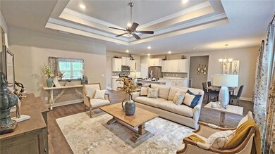 Living room featuring ceiling fan with notable cha
